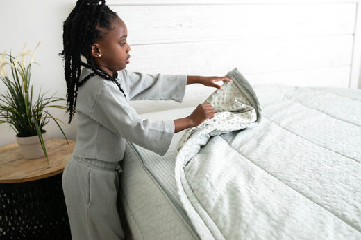 
      Young girl zips up her zipper Bed-dys bedding.
    