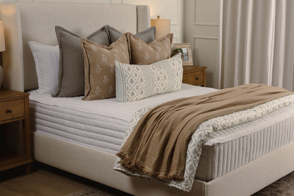 White stripe quilt zipper bedding with tan, gray, and floral accessories.