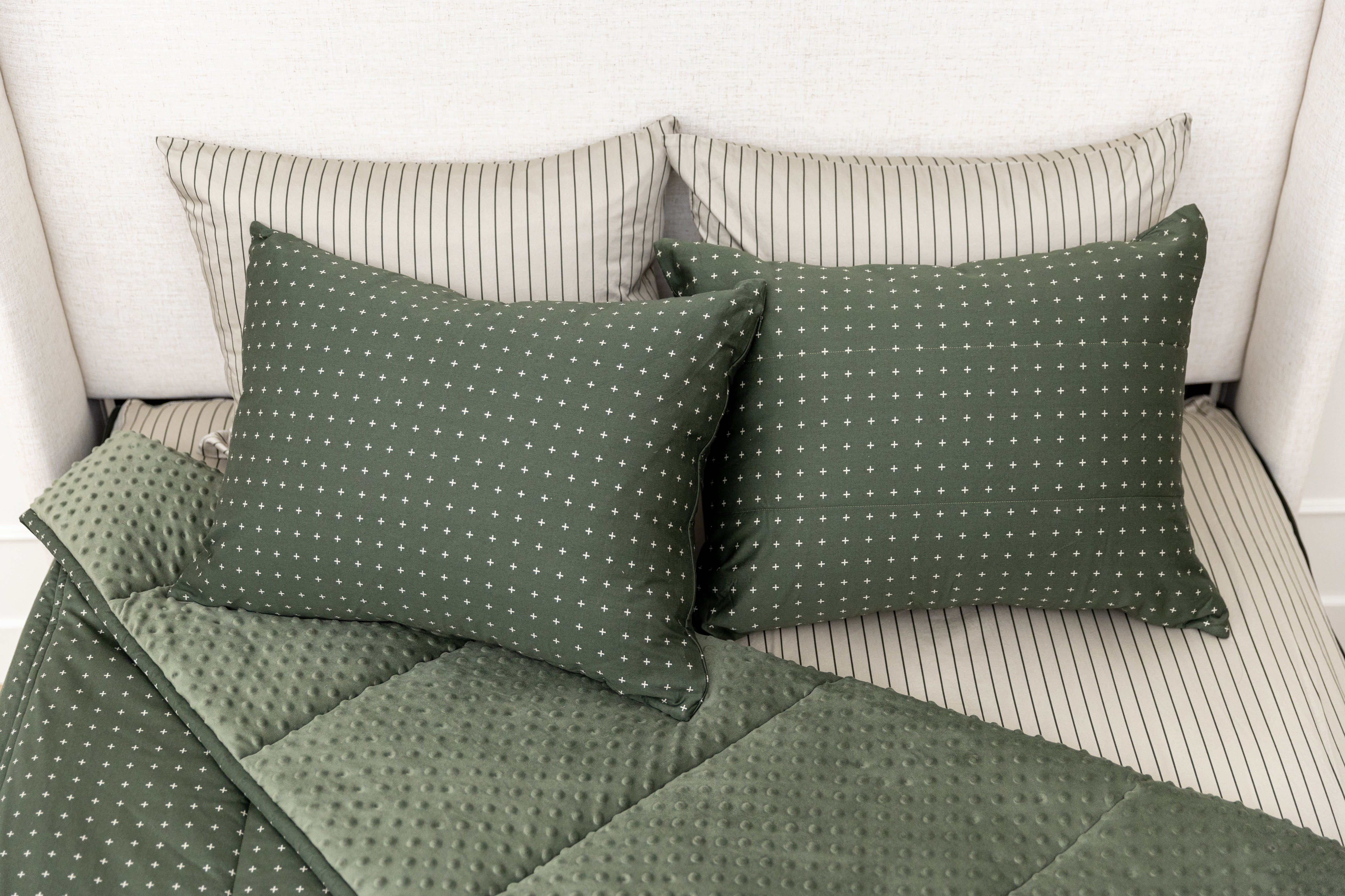 Overhead shot of green zipper bedding showing pillowcases and shams