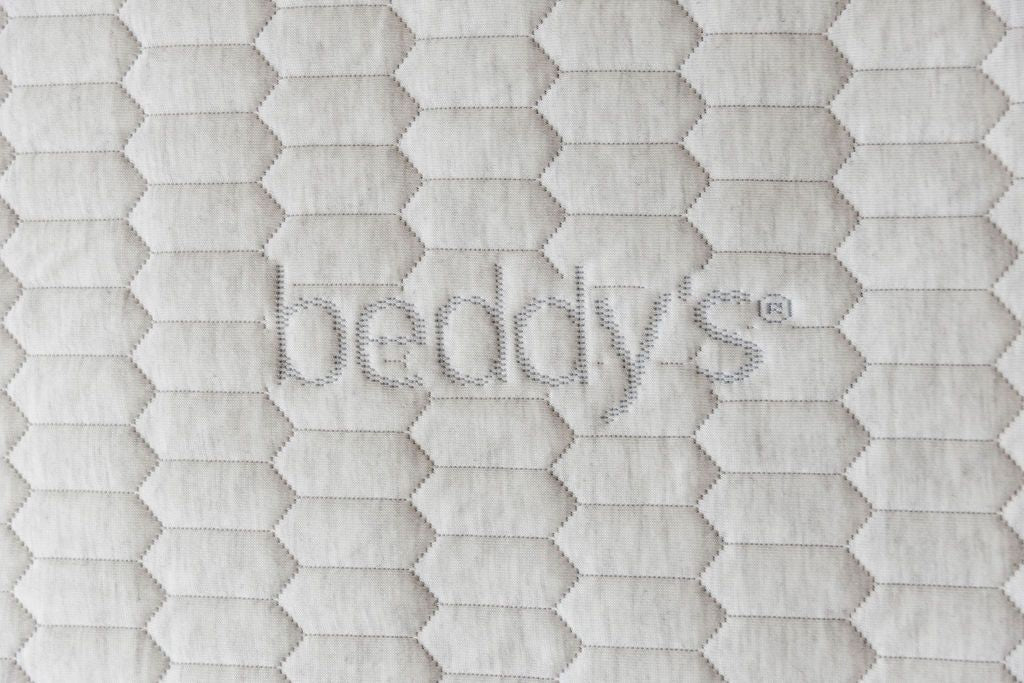 A close up of the Bed-dys logo on a zipper mattress,